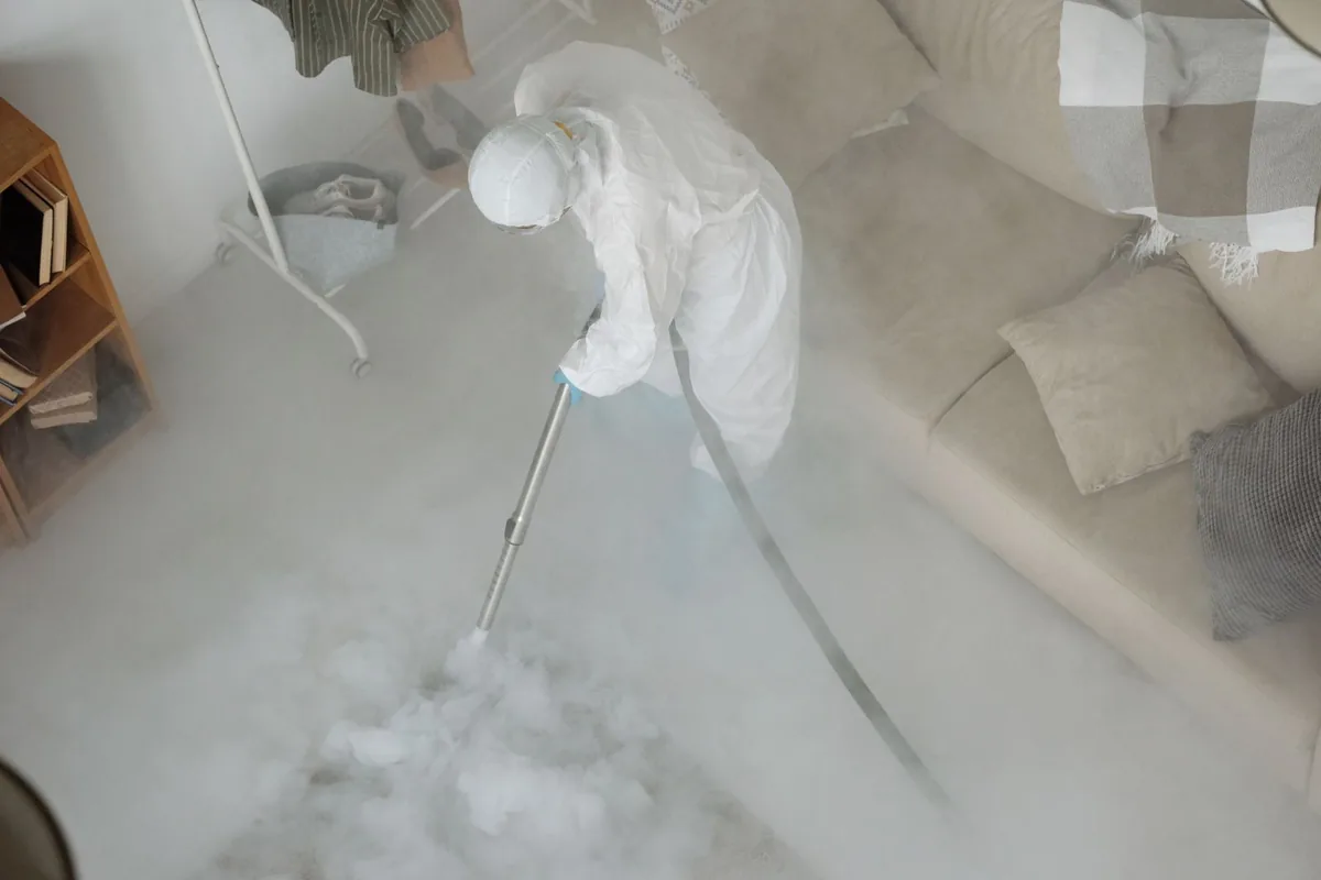 Biohazard cleanup technician in protective equipment, Wood Streets, Riverside, CA